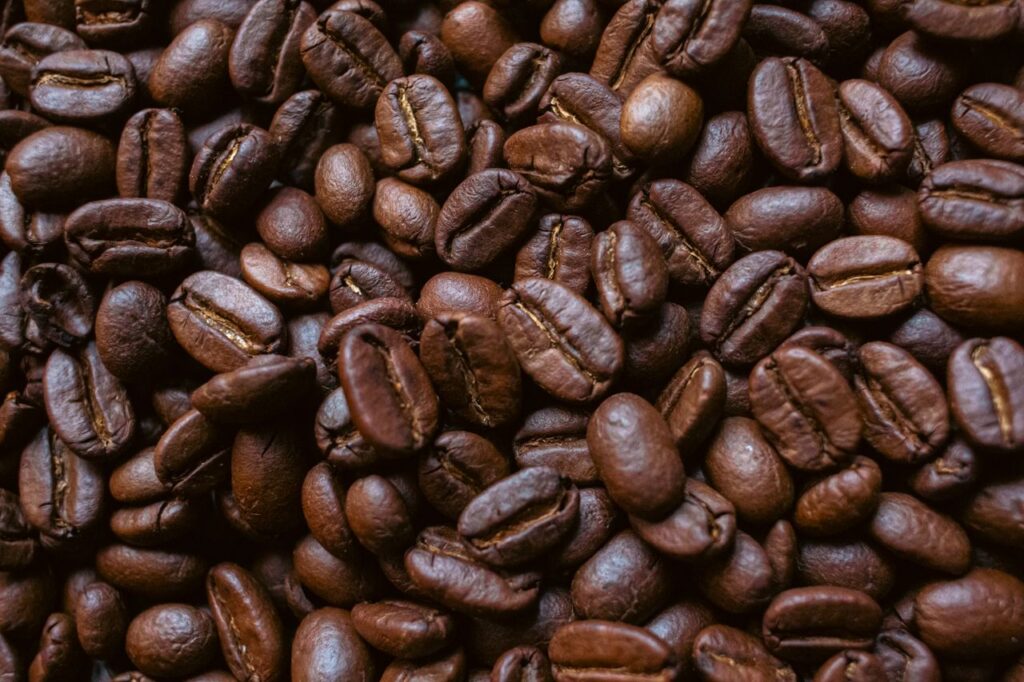 Detailed close-up of roasted coffee beans with rich aroma and texture, perfect for beverage themes.